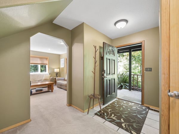 Step through the welcoming entrance into a bright, open space where natural light and fresh air greet you. The adjoining living area invites you to settle in and unwind.