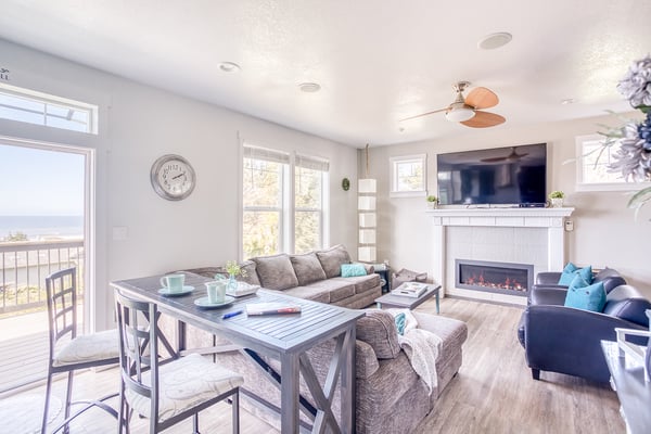 Unwind in your bright, open living space with cozy fireplace and stunning views through floor-to-ceiling windows.
