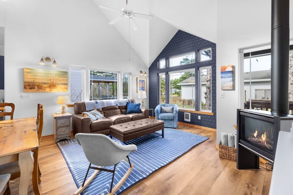 Cozy up in this light-filled living room with vaulted ceilings, where you'll love relaxing by the fireplace after exploring.