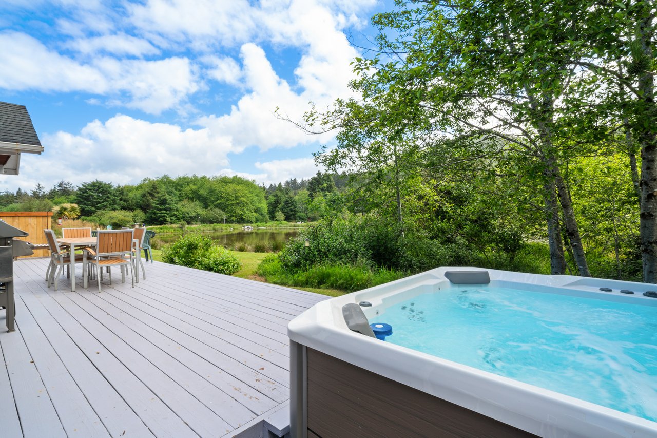 Soak in your private hot tub while gazing at tranquil pond views, then dine al fresco surrounded by lush greenery and forest serenity.
