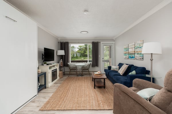 Sink into plush seating and unwind in your bright, airy living room. Natural light floods the space through large windows, while coastal artwork and a cozy fireplace create a relaxing retreat after exploring nearby attractions.