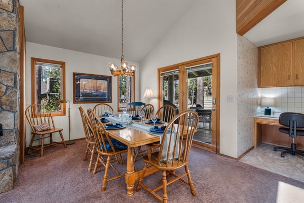 Gather around your elegant wooden dining table where warm meals and conversations flow beneath the gentle glow of ambient lighting.