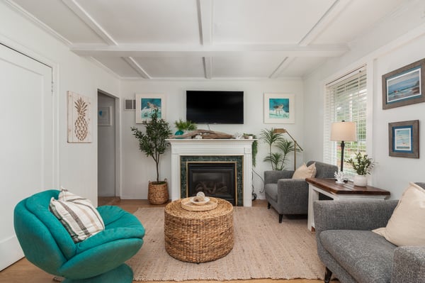 Unwind in your light-filled living room, where coastal style meets cozy comfort. Curl up by the fireplace or sink into plush seating surrounded by beach-inspired decor.