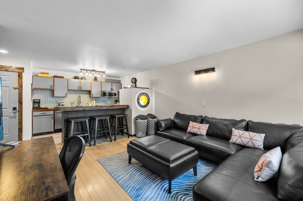 Relax in your stylish open-concept space where the plush leather sectional invites movie nights while the modern kitchen awaits your culinary adventures.