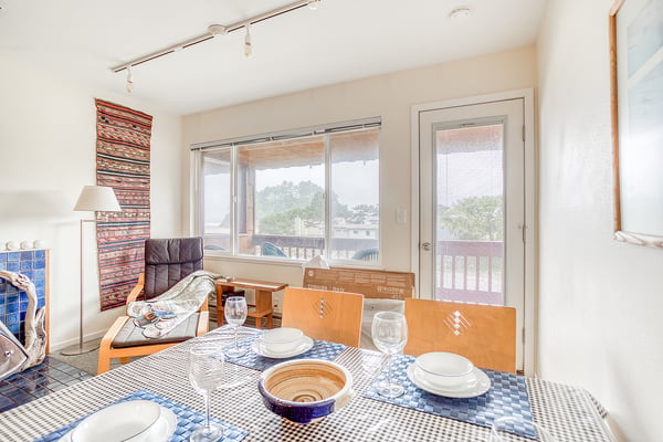 Savor meals at your private dining table, where natural light streams through wide windows showcasing tranquil views and gentle breezes from your personal balcony just steps away.