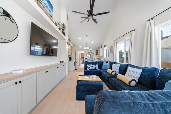 Sink into plush blue sectionals beneath soaring ceilings with plenty of natural light streaming in, creating your perfect space to relax after a day exploring.