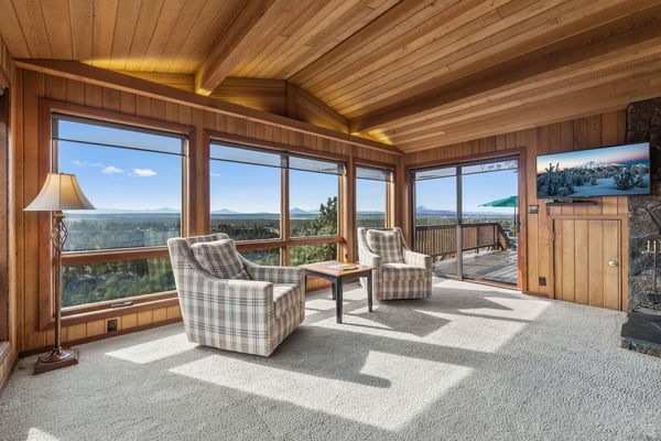 Relax in comfort while sweeping views of distant islands and pristine forests stretch out before you through floor-to-ceiling windows in this inviting living space.