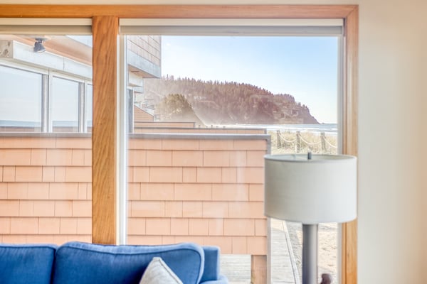 Relax in your cozy seating area while taking in stunning hillside views through large windows that frame the natural beauty beyond.