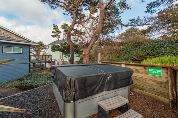 Soak under the stars in your private hot tub, surrounded by mature trees and coastal charm.