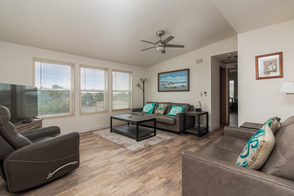 Settle into this bright living room with stylish wood-look floors and modern furnishings—perfect for relaxing after your adventures or enjoying the peaceful view.
