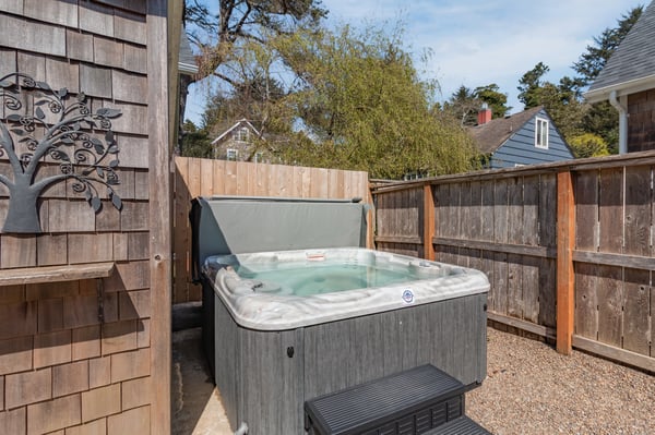 Slip into your private hot tub and let warm bubbles melt away stress in this peaceful backyard retreat.