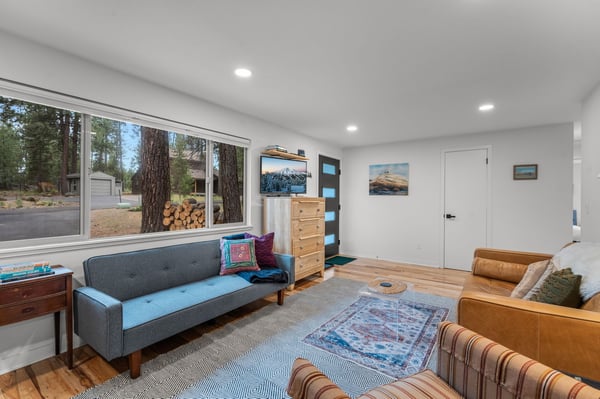 Unwind in this bright, comfortable living space with cozy seating and natural light from large windows. Relax and recharge in your mountain retreat.