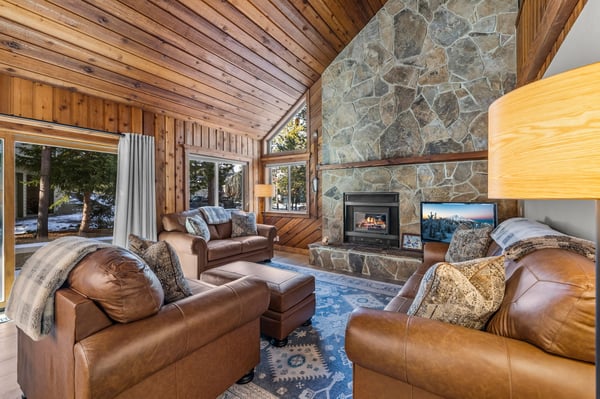 Cozy up in luxury leather seating by your crackling stone fireplace, where mountain views frame perfect evenings.