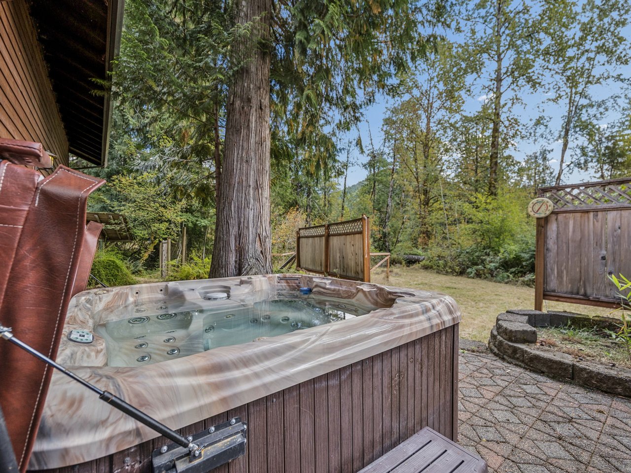 Slip into your private hot tub and unwind beneath towering trees, surrounded by peaceful natural beauty and complete seclusion.