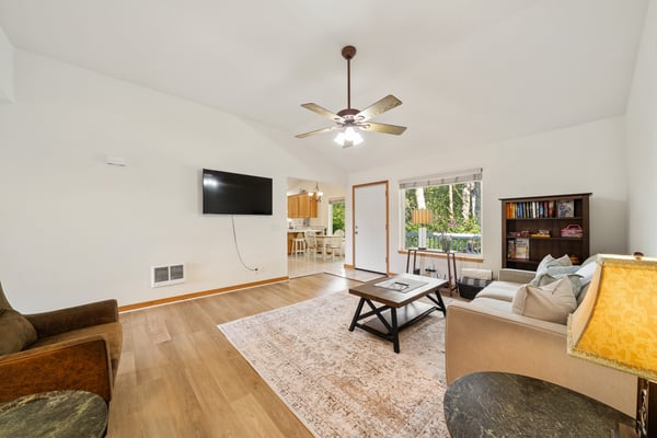 Unwind in your spacious living room, where natural light pours through large windows and a ceiling fan keeps you comfortable. Perfect for cozy evenings or catching up with loved ones.