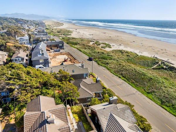 This beachfront property sits along a pristine stretch of sandy coastline, bordered by lush coastal vegetation and offering stunning ocean views. The peaceful neighborhood provides easy access to miles of unspoiled beach.