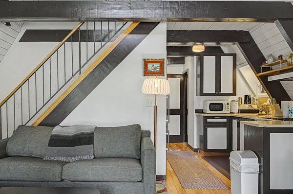 Your stylish loft features exposed beams, a cozy living area, and a fully equipped kitchen—perfect for relaxing after a day exploring nearby attractions.