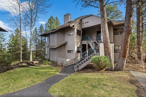 Modern vacation rental nestled among towering pines, offering peaceful forest surroundings and convenient outdoor access.