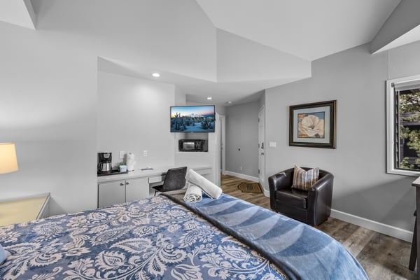 Relax in your thoughtfully designed room with cozy seating, fresh coffee station, and modern comforts awaiting your arrival.