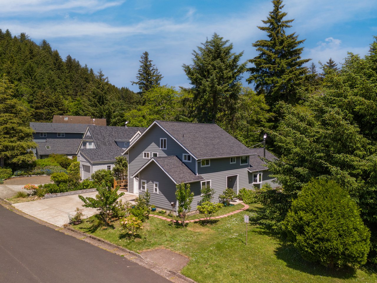Aerial view of the property nestled in a peaceful, tree-lined neighborhood, offering a private retreat surrounded by natural beauty and tranquil surroundings.