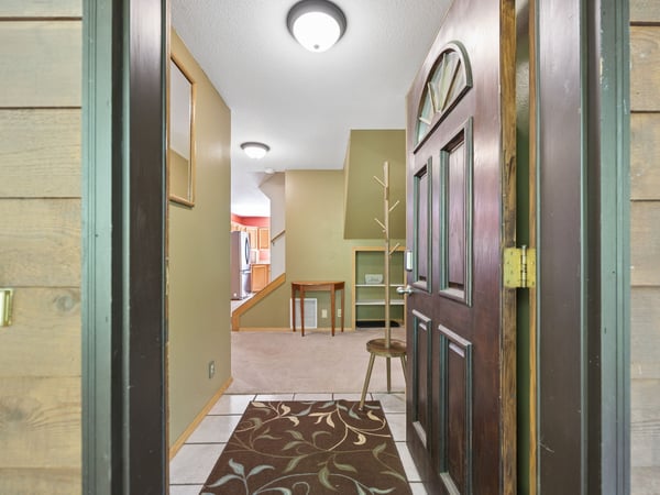 Step through the welcoming entryway into your home away from home, where warm wood tones and thoughtful touches set the stage for your stay.