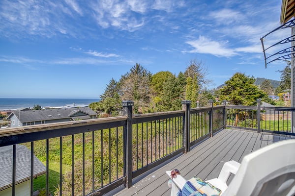 Relax on your private balcony with stunning ocean views, where coastal breezes meet comfortable outdoor seating.