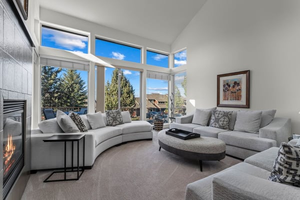 Sink into plush seating while natural light floods your space through floor-to-ceiling windows, creating the perfect backdrop for relaxing moments.