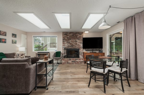 Gather in this sunlit open space where exposed brick, warm wood tones, and comfortable seating invite you to relax after a day of exploring.