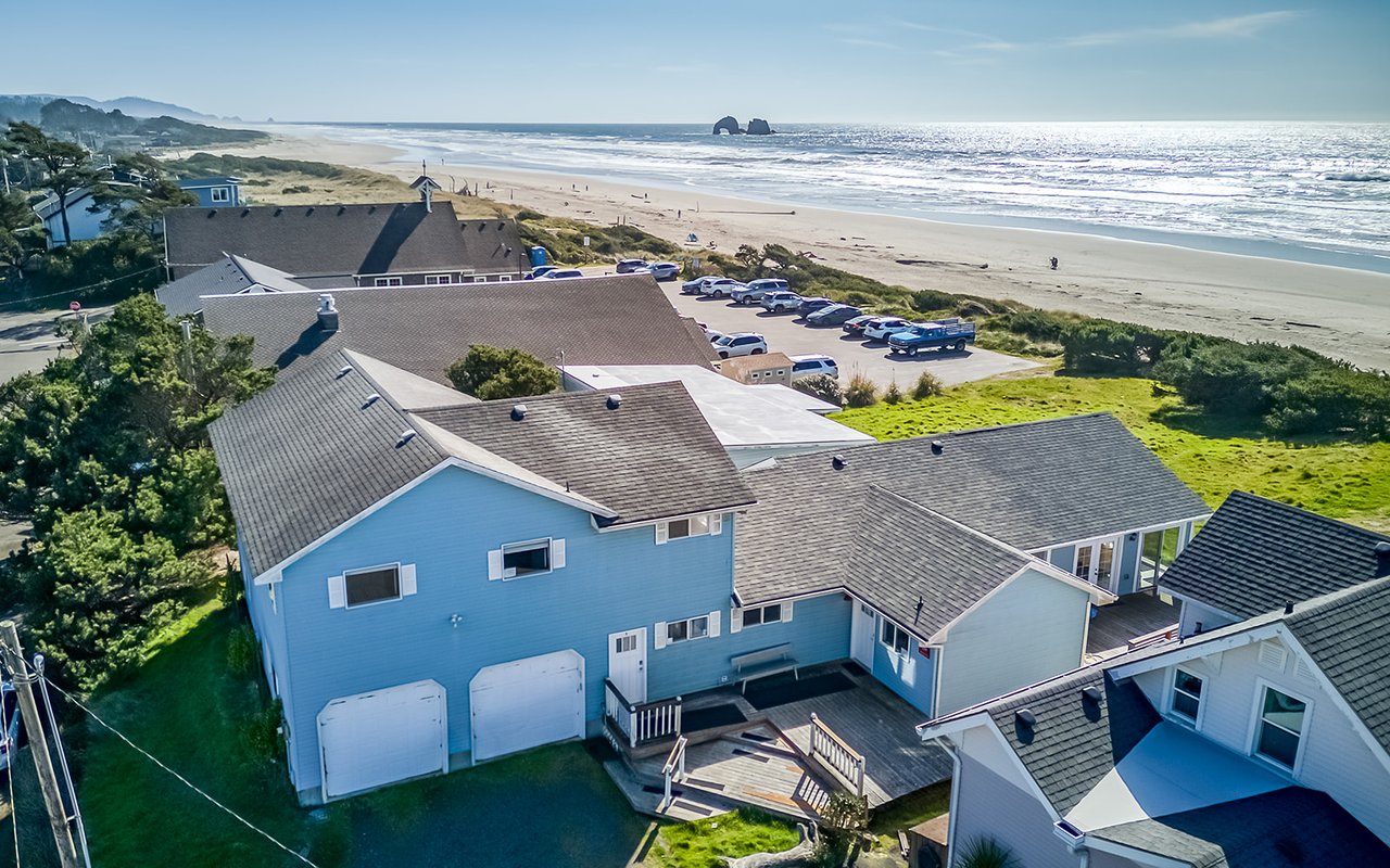Stunning coastal property with beach access and ocean views from this aerial perspective of the surrounding area.