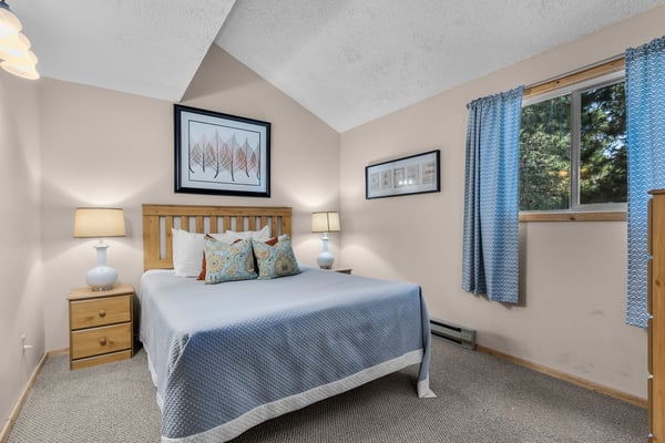 Your peaceful mountain retreat features vaulted ceilings, warm wood accents, and views of the surrounding pines. Natural light fills the cozy space, inviting restful nights.