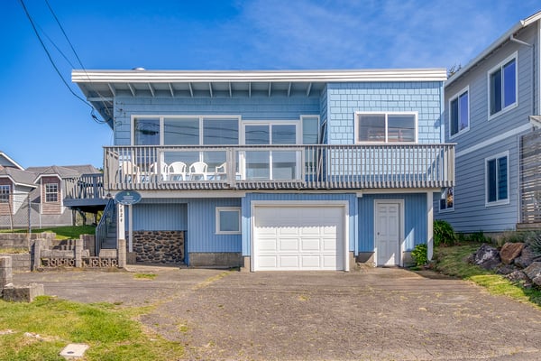 Charming coastal home with spacious deck and convenient garage parking in quiet neighborhood setting.