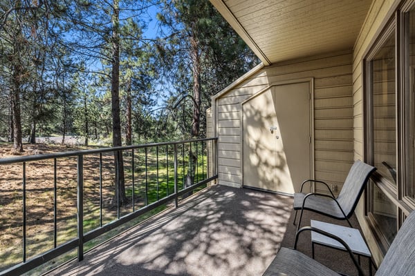 Settle into your private balcony where towering pines frame peaceful forest views, perfect for morning coffee or unwinding after mountain adventures.
