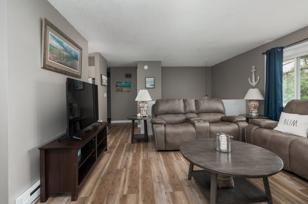 Unwind in your spacious living room with plush recliners, coastal touches, and plenty of natural light for relaxing after a day of adventure.