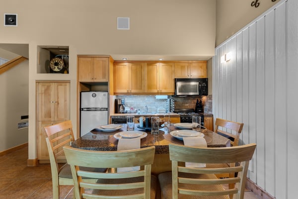 Gather around this inviting dining space, where you'll find everything you need to prepare and enjoy memorable meals together in your cozy mountain retreat.