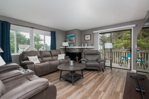 Sink into plush seating with your favorite people and let the natural light and treetop views embrace your getaway—your cozy retreat awaits.