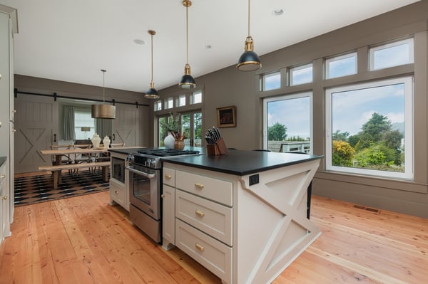 Step into a spacious chef's kitchen with abundant natural light, stylish pendant lighting, and modern appliances ready for your culinary adventures.