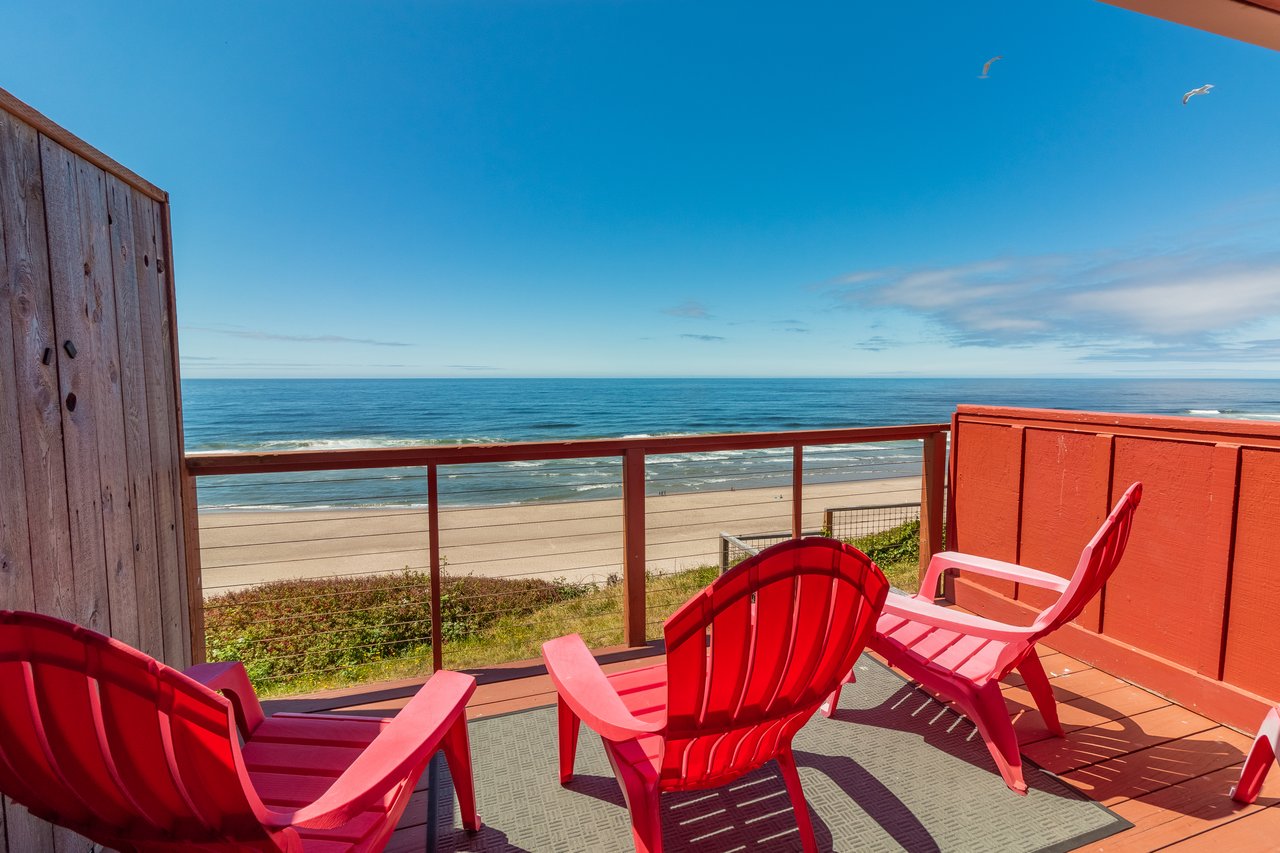 Step out to your private deck and settle into a sunny beach chair overlooking pristine sand and endless ocean views, where gentle waves and seabirds welcome your escape.