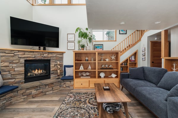 Unwind by your crackling fireplace while enjoying the warm glow and cozy seating that makes this living space perfect for relaxation.