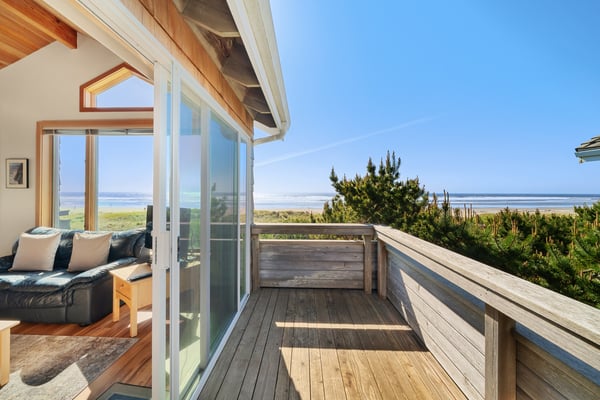 Beachfront property featuring expansive ocean views, direct access to sandy shores, and a spacious deck overlooking coastal dunes and pristine natural landscape.