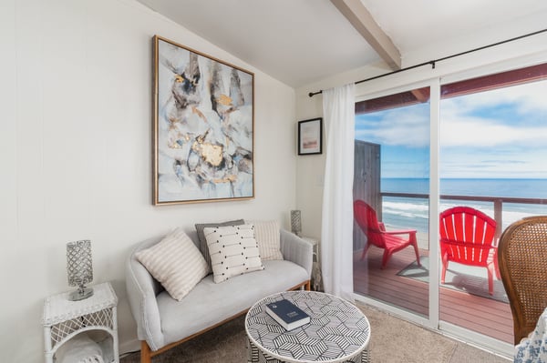 Settle in with your favorite book in this serene coastal retreat, where calming neutral tones frame sweeping ocean views just beyond your private deck.