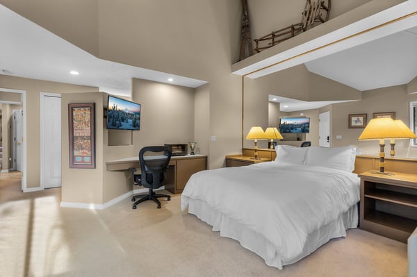 Drift off in your spacious loft bedroom with soaring ceilings and warm lighting that creates the perfect retreat.