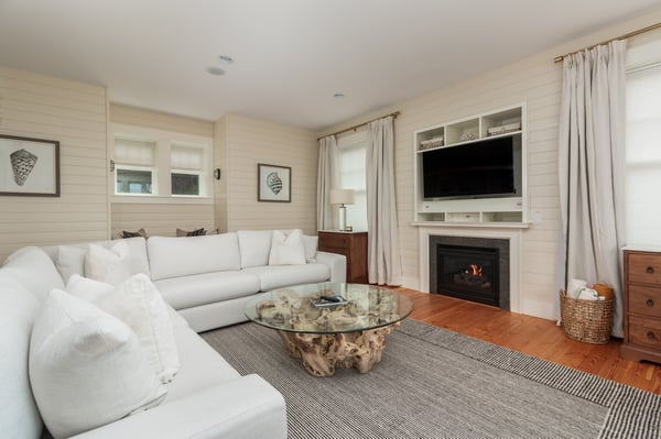 Sink into plush seating and unwind by the warm glow of your private fireplace, perfect for cozy evenings after exploring the coast.