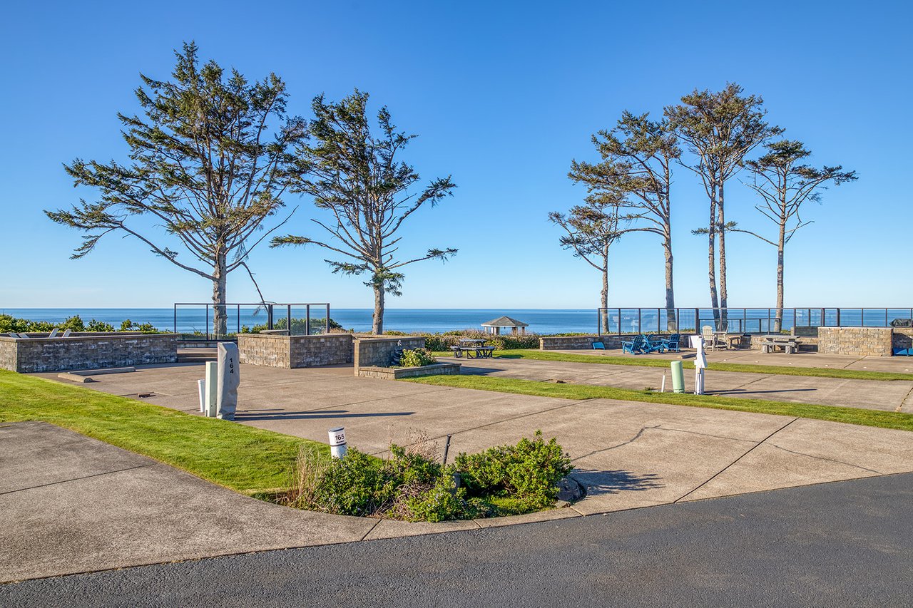Coastal park with mature trees and ocean views creates a scenic setting near the property.