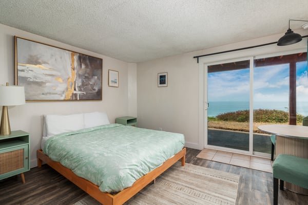 Wake up to breathtaking ocean vistas right from your bed, with a private sliding door leading to coastal serenity and the gentle sound of waves just beyond.