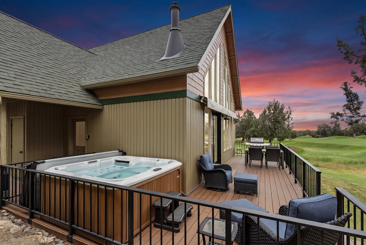 Stunning sunset views over the golf course highlight this spacious deck, perfect for soaking in the hot tub or dining al fresco after a day of exploration.