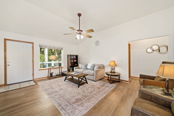 Unwind in your bright, open living room with vaulted ceilings, warm wood accents, and plenty of natural light—perfect for relaxing after a day of adventure.