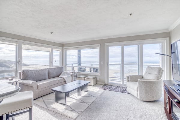 Unwind in your bright living space with panoramic ocean views and plush seating perfect for morning coffee or evening relaxation.