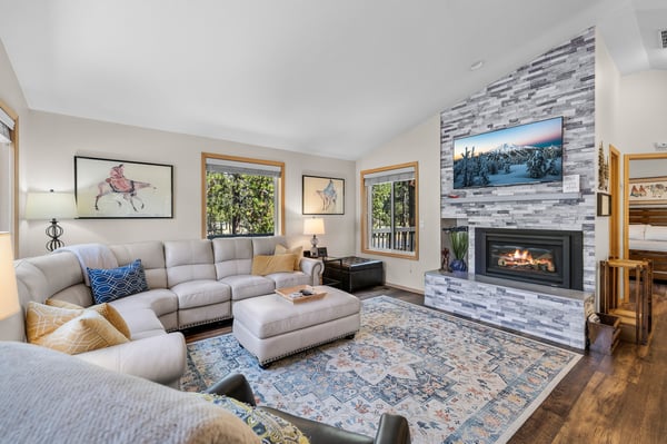 Sink into plush sectional seating surrounded by warm wood tones and the gentle glow of your private fireplace—your perfect retreat after a day exploring the mountains.