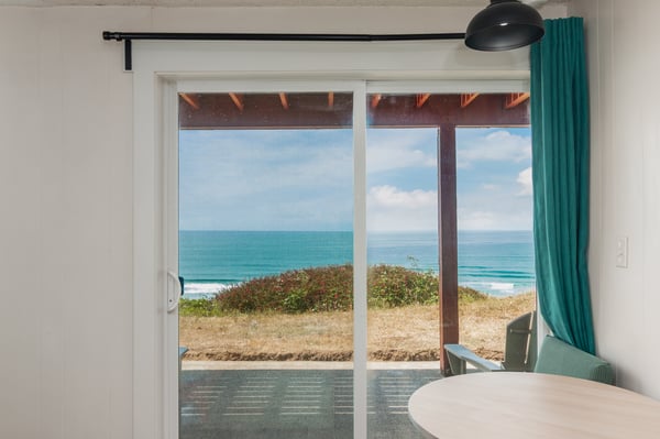 Step through the glass door to your private covered patio, where gentle ocean breezes meet breathtaking views of the sparkling sea just steps away.
