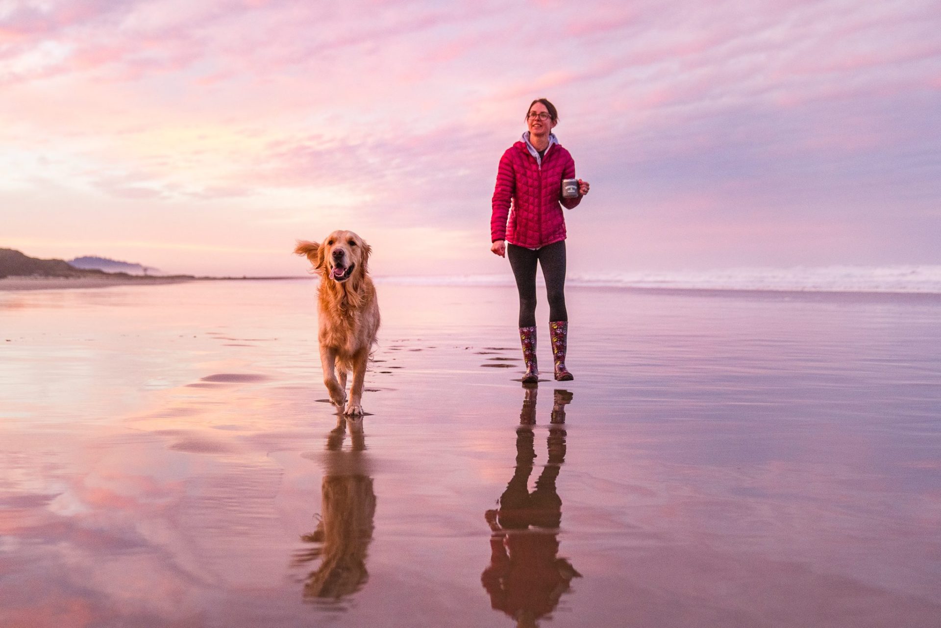 Dog and Woman at sunset in Rockaway Beach, Oregon